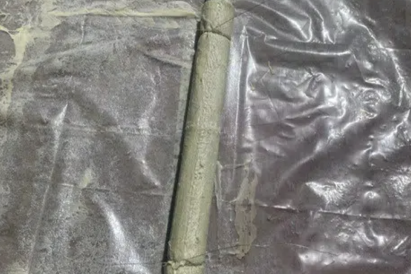 No-dig patch repair being prepared for installation in damaged drainage pipework