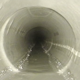 Completed internal patch repair visible inside drainage pipework