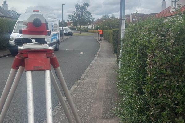 Dumpy level set up on a street to measure survey levels