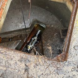 Crawler CCTV camera inspecting underground drainage from a manhole