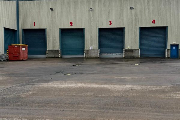 Site photograph documenting drainage survey work at the Livingston warehouse