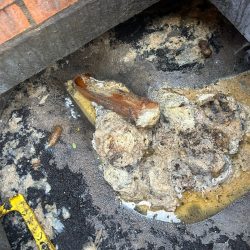 Displaced drainage pipe visible inside a manhole
