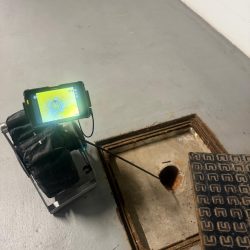 CCTV drainage inspection being carried out through a manhole